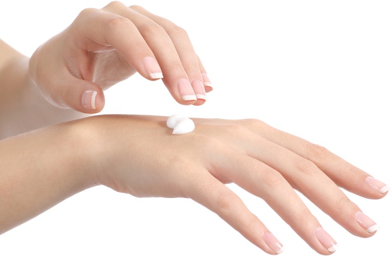 Applying skin care cream to hands