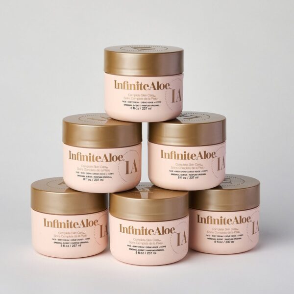 Six light pink jars of IA Skin Care Six-Pack - Original are stacked in a pyramid on a plain white background, each featuring gold lids and gold text on the front.