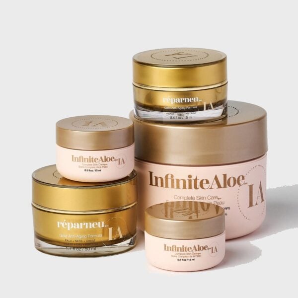 Five pink and gold jars from the Ultimate Beauty Collection are arranged on a light gray background, featuring varying sizes stacked together in an elegant display.